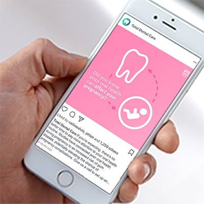 A phone featuring a social media post discussing the link between oral care and pregnancy