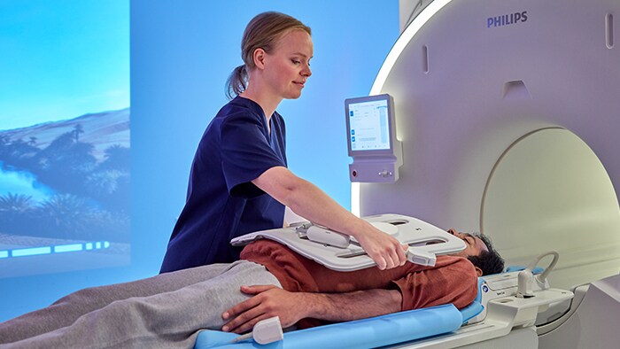 Nurse preparing patient to go in CT machine