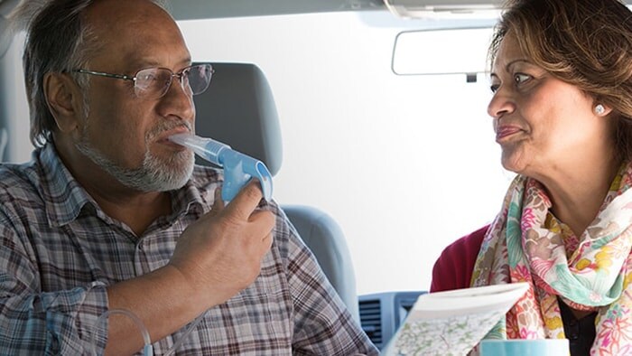Patient in car with breathing device