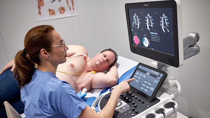 Doctor looking at monitor as patient lies on table