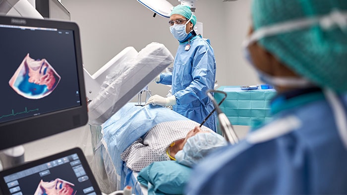 Doctor looking at a screen during surgery as images are displayed on the screen