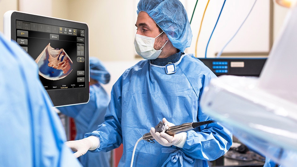 Doctor looking at screen while using device