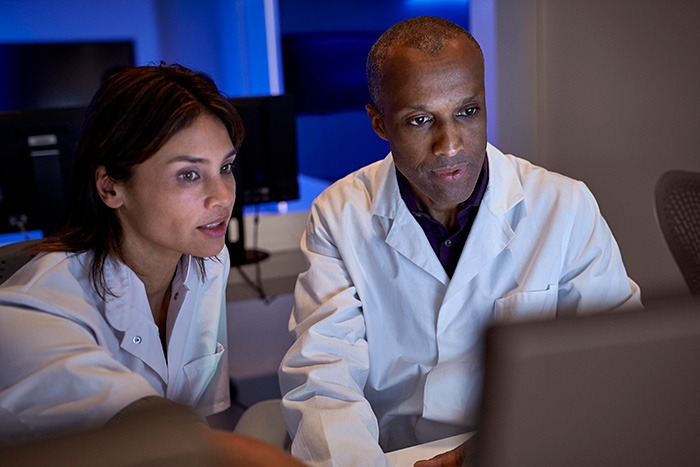 Two doctors looking at a screen while one points to something on the screen