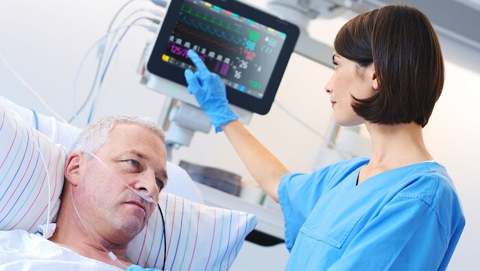 Doctor using monitor for patient
