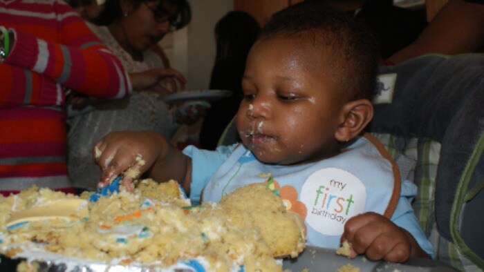 Infant eating cake