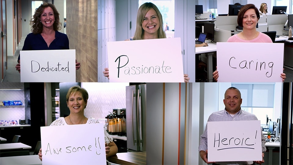 Philips employees holding up signs with positive words that describe Respiratory Therapists