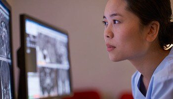 Clinician looking at a computer screen