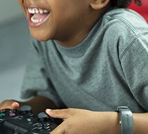 Kid playing video games while wearing actiwatch