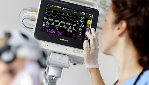 a clinican checking the patient's healthcare parameter on a device