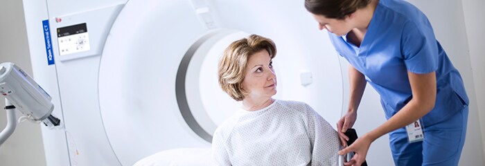 Medical professional reaching towards patient's arm