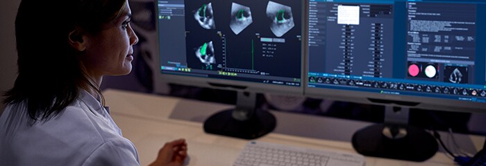 Doctor monitoring two screens