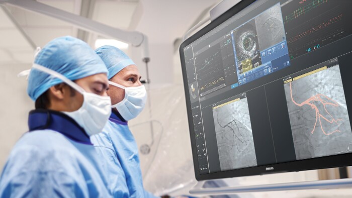 Doctors looking downwards to health monitor