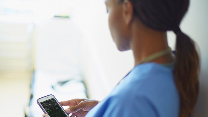 Healthcare professional glancing at phone