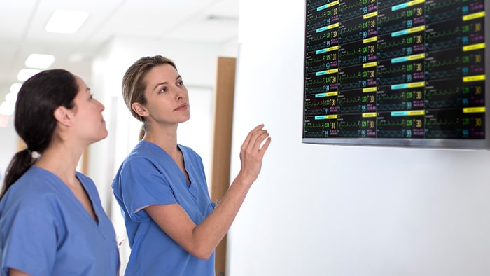 Two healthcare professionals glancing at screen