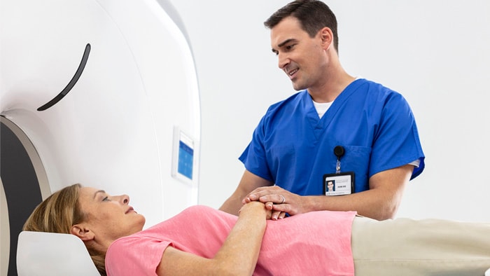 Healthcare professional with patient using CT scan