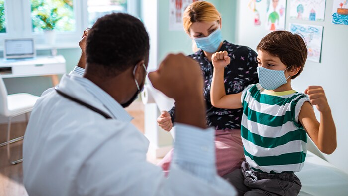 Healthcare professionals with masked child