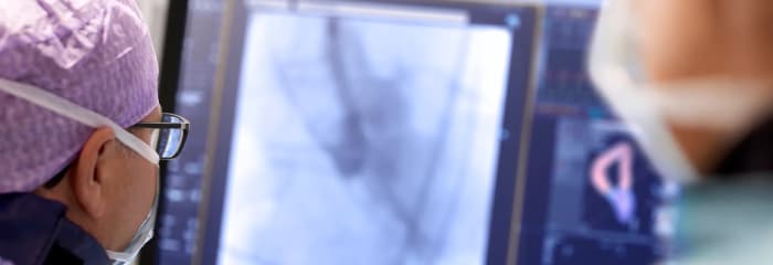 Doctor from behind monitoring screen