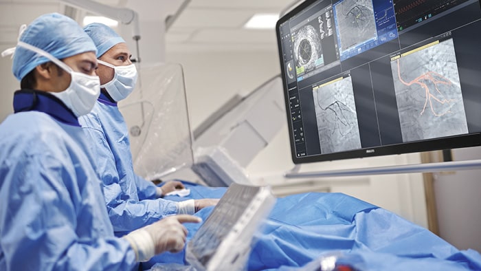 Doctors looking at screen during procedure