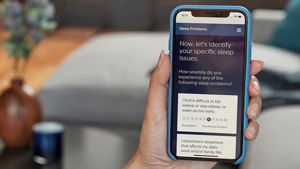 Person holding phone taking sleep apnea quiz