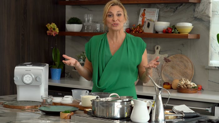 Lady making recipe with the pasta maker