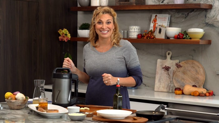 Lady making recipe with soup maker