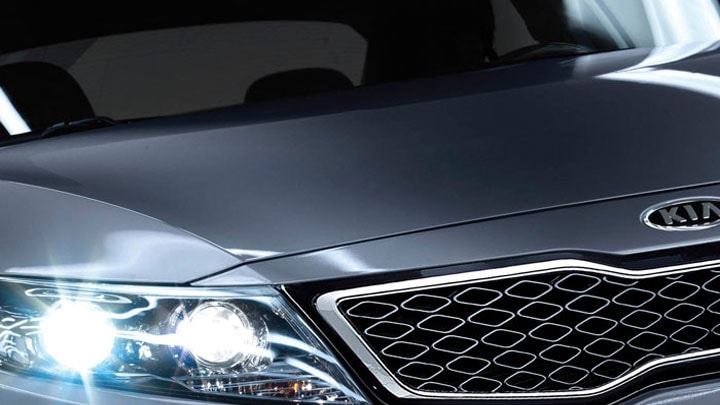 Close up of a the front end of a car, driving in a tunnel