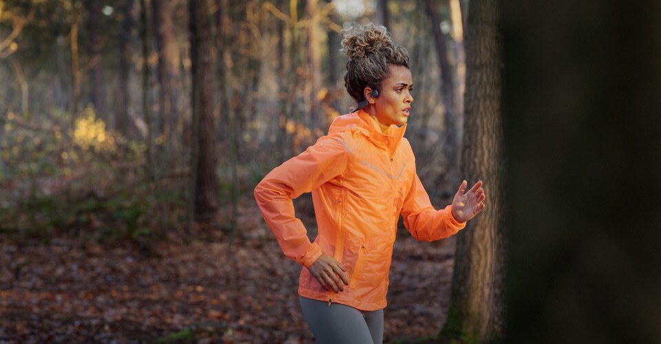Athlete using wireless bone conduction headphones for outdoor running