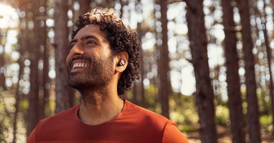 Athlete shown wearing true wireless earbuds