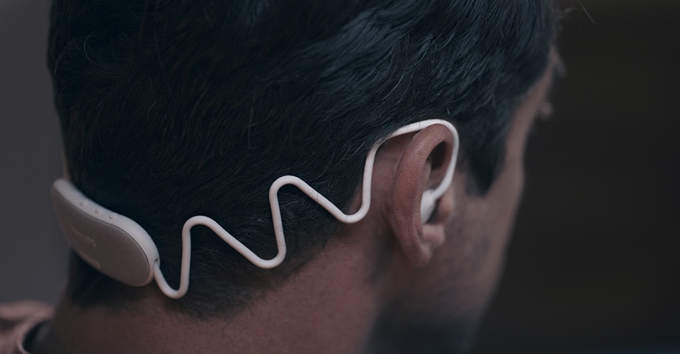Image showing Philips Sleep Headphones that fit around a man’s head tightly, but comfortably.