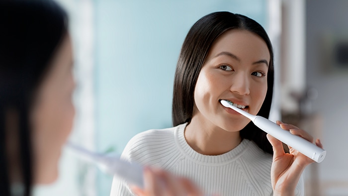 Woman brushes teeth