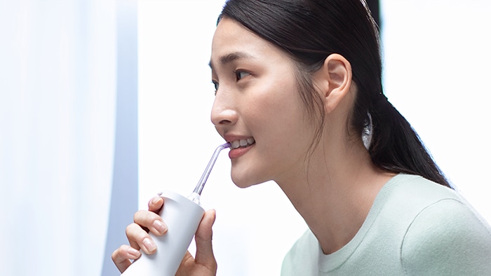 Woman brushes teeth