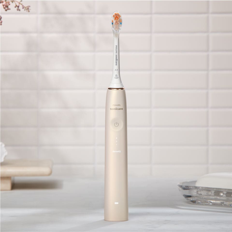 Philips Sonicare Prestige 9900 power toothbrush with All-in-One brush head standing on a countertop