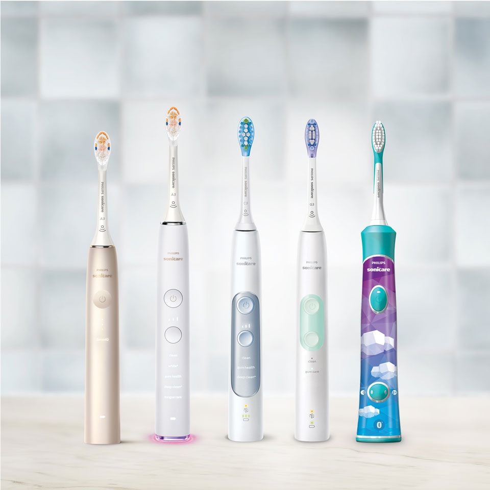 Sonicare power toothbrushes aligned on a countertop