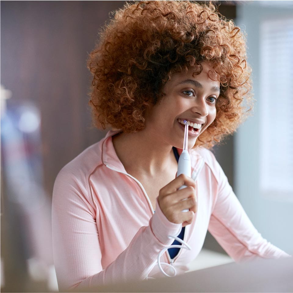 Woman using a Power Flosser