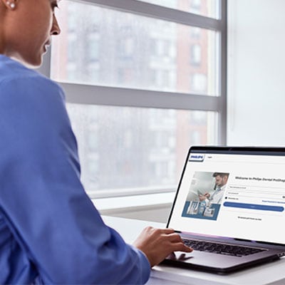 A dental professional ordering Sonicare solutions on a laptop