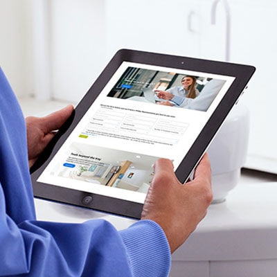 A dental professional creating a customer account using a tablet