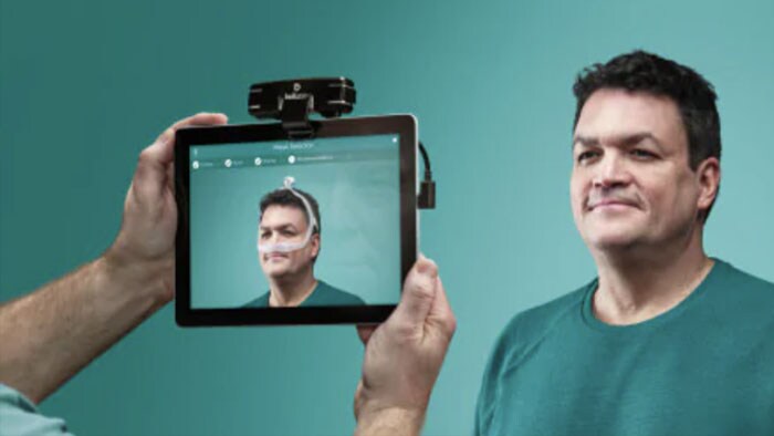 Man looking into tablet camera