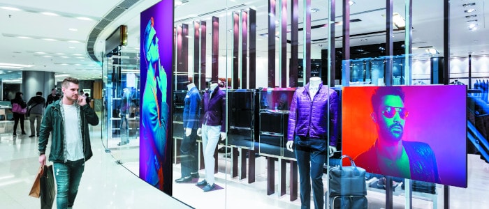 Dynamic digital signage - LED Videowall | A guy walking around a store