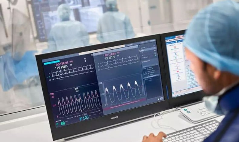 Clinician seated at computer reviewing images 